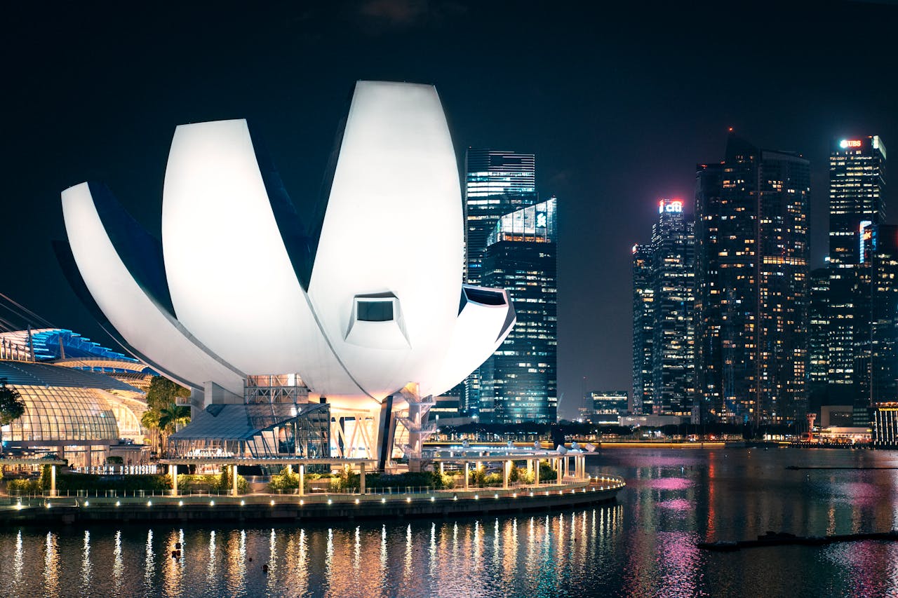 Dramatic night view of Singapore's skyline featuring the iconic ArtScience Museum.